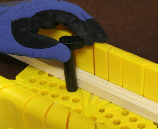 Figure 4. Some miter boxes provide cams that you turn to hold the wood in position.
